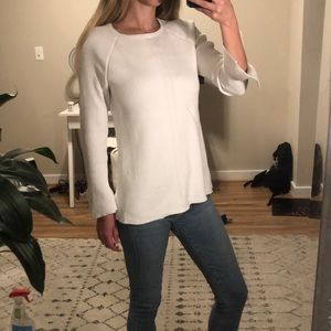 White sweater with split sleeve detail at wrist